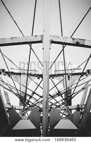 Symmetrical metal construction abandoned children's attraction, black and white.