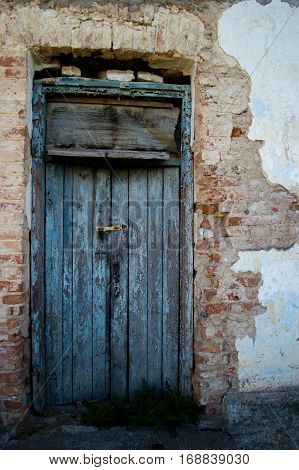 Old locked door in a shabby and cracks with a new lock.