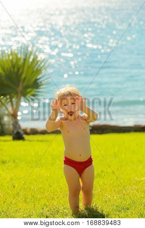 Cute Cheerful Baby Boy Makes Frightening Attacking Gesture