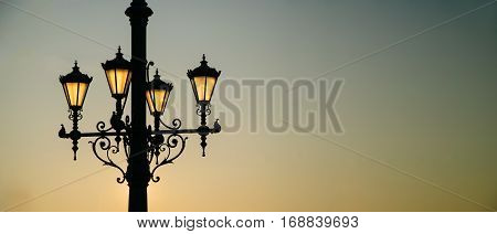 Street lamp lights at sunrise time. Banner with copy space for your text