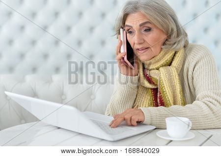Portrait of a senior woman using laptop, close up