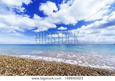 Beautiful sea paradise beach on a background of blue sky with clouds.