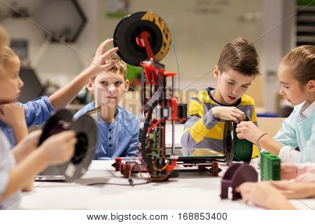education, children, technology, science and people concept - group of happy kids with 3d printer at robotics school lesson