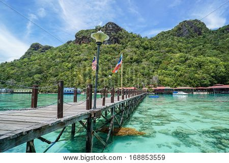 Bohey Dulang,Semporna,Sabah-Sept 10,2016:Jetty at Bohey Dulang,Semporna,Sabah with background of beautiful island of Bohey Dulang on 10th Sept 2016.Bohey Dulang Island is one of the most popular and attraction islands in Tun Sakaran Marine Park.