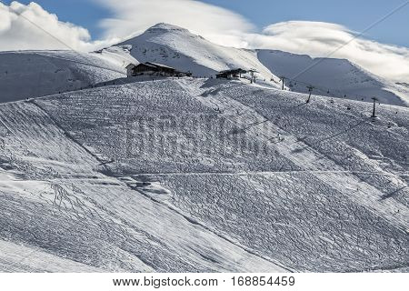 Ski domain located at high altitude in Alps in Beaufortain Massif in Haute-Savoie close to Mont Blanc. In the distance can be seen Mont Joly peak at 2525 m .