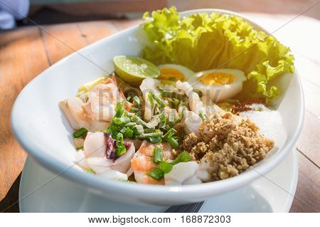 Top view spicy seafood Salad ingredient with squid shrimp fish and egg Thai food.