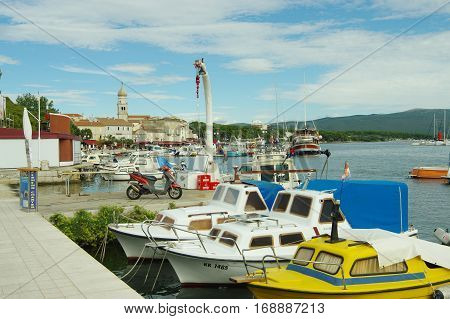 Krk Croatia - September 19 2016: a town in the south of the island of Krk. It is a tourist resort preserved fragments of buildings from Roman times. Harbor. On the waterfront moored many boats and yachts.