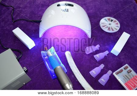 Nail gel salon. Beautiful woman hand and lamp UV  for nails UV with timer