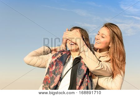 Girl make emotional surprise to her bestfriend covering eyes with hands. Happy and smiling best friends having emotional fun together around city and shopping. Memory photo about happy life moments