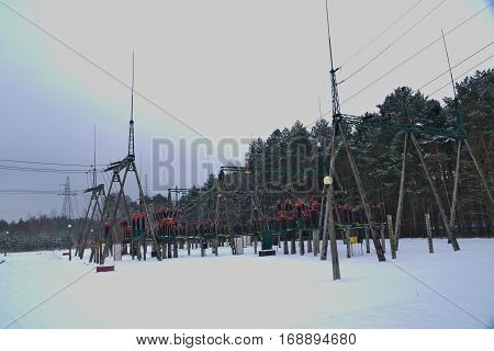 The photo shows the installation of terrestrial stations electro energy. In the photo are visible pillars of odgromnikami, power lines and ceramic insulators. It is winter, Teran stations cover layer of snow.