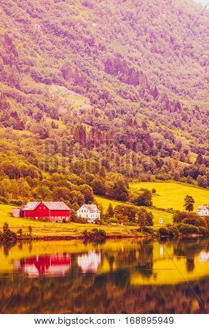 Norwegian Country Houses In The Mountains On Lake Shore