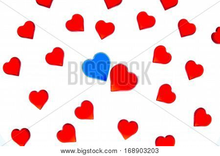 Bright red hearts on a striped background with blue and red hearts. In order to use Valentine's Day, weddings, International Women's Day