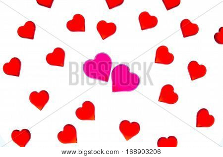 Bright red hearts on a striped background with two pink hearts. In order to use Valentine's Day, weddings, International Women's Day