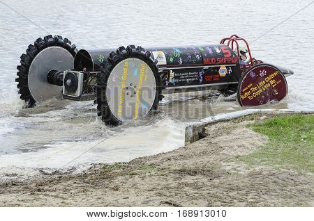 NAPLES FLORIDA/USA - MARCH 3 2012: Swamp buggy eases into water for next race
