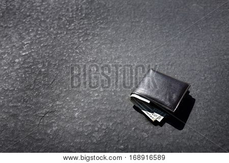 Lost wallet lying on street or roadway road path with cash