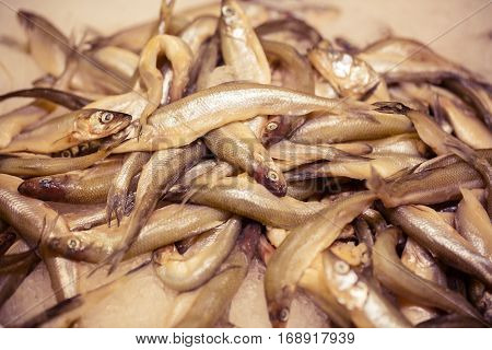 Raw smelt fish in the store like background