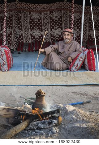 Muscat Oman February 4th 2017: omani man with a walking stick resting