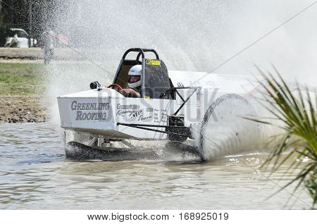 Naples Florida USA - March 3 2012: Swamp buggy cranking through straightaway