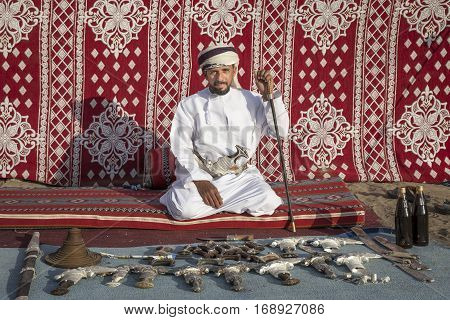 Muscat Oman February 4th 2017: omani man selling traditional khanjar daggers