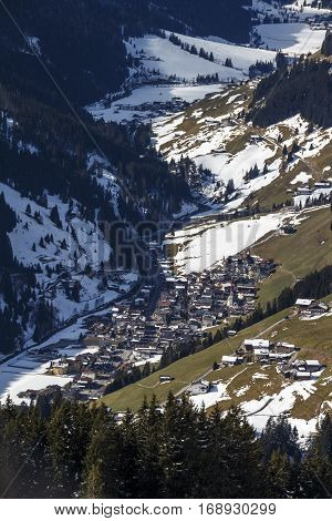 View on a village from Rastkogel cableway in Tyrol Austria with skier in front