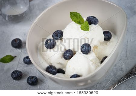 Vanilla Ice Cream with blueberries in bowl Summer refreshing dessert. Top view