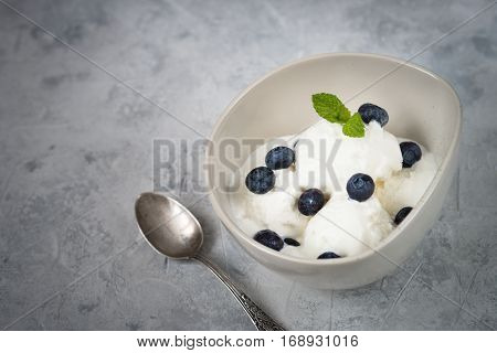 Vanilla Ice Cream with blueberries in bowl Summer refreshing dessert. Top view
