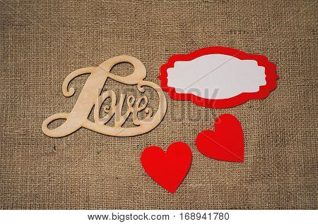 Hearts flowers ribbons on a wooden light background