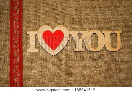 Hearts flowers ribbons on a wooden light background