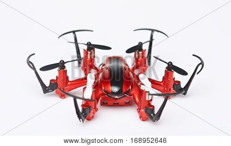 One red toy drone isolated on white background. Close up of drone front view