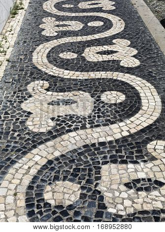 Detail of the traditional Portuguese cobblestone pavement seen in many streets and squares of Lisbon Portugal