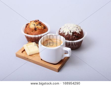 Classic style espresso shot with chip muffin and coffee beans on white background