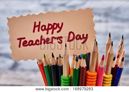Colorful pencils and greeting card. Bright congratulation to Teacher's Day.