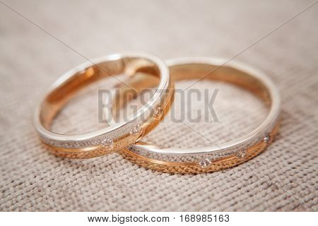 Two beautiful golden wedding rings with brilliants close-up. Selective focus