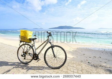 Woman Tourist Cycling Around The Beautiful Beaches, La Digue Island, Seychelles
