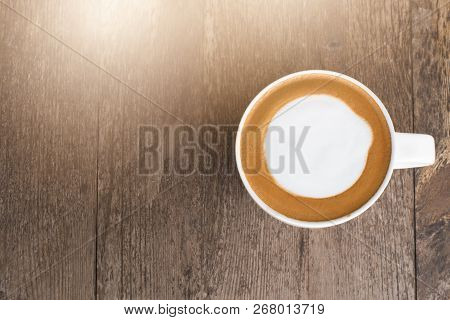 Hot Coffee With Foam Milk On Wooden Background.