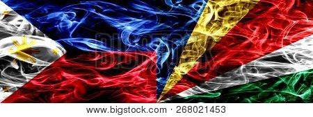 Philippines Vs Seychelles, Seychelloise Smoke Flags Placed Side By Side. Thick Abstract Colored Silk