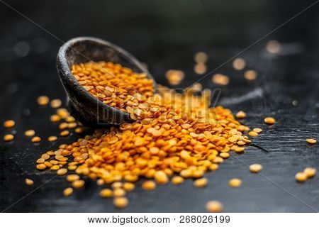 Close Up Of Raw Masur Dal Or Masoor Lentils Or Pink Lentils In A Black Colored Clay Bowl On Wooden S