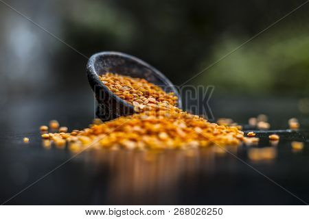 Close Up Of Raw Masur Dal Or Masoor Lentils Or Pink Lentils In A Black Colored Clay Bowl On Wooden S