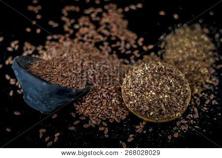 Close Up Of Ayurvedic Herb Alsi Or Adsi Or Flax Seed In A Black Colored Clay Bowl With Its Powder On