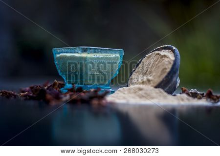 Close Up Of Popular Way Of Ex Foliating On Wooden Surface I.e. Multani  Mitti Or Fuller's Earth Well