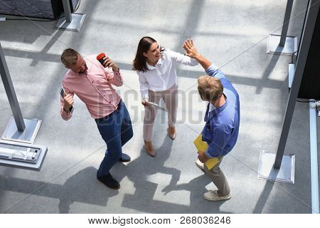 Top View Of Young Modern Colleagues In Smart Casual Wear Working Together While Spending Time In The