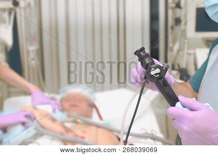 Medical Workers Team Prepares To Bronchoscopic Procedure To The Citical Patient In The Icu.