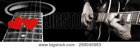 Playing An Acoustic Guitar. Guitarist Hands And Guitar. Red Hearts On The Strings Of A Guitar. Heart