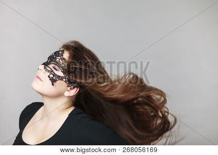 Pretty Mysterious Woman Wearing Black Eye Lace Mask Having Tousled Windblown Long Brown Hair.