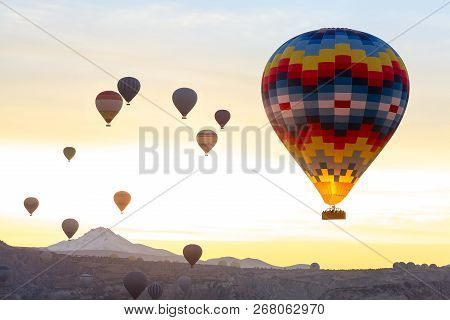Color Aerostat In The Foreground. Many Balloons In The Air Against The Sunrise.