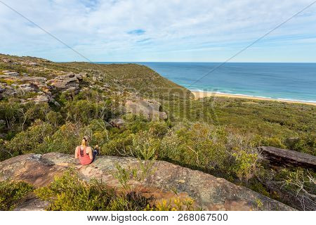 Weekend Time, Casual Dressed Female Relaxing On A Rock Ledge With Views To The Ocean