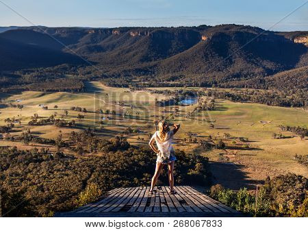 Woman Standing On An Old Timber Platform Views Over Kanimbla Valley And Blue Mountains Escarpment In