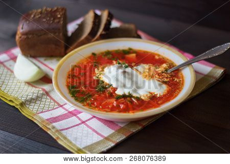 Traditional Ukrainian Russian Borscht On The Bowl. Plate Of Red Beet Root Soup Borsch On Black Rusti