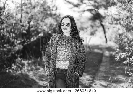Pretty Long Hair Bruntte Girl Walking In The Autumn Forest.