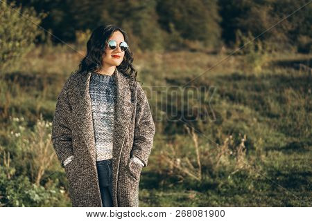 Pretty Long Hair Bruntte Girl Walking In The Autumn Forest.
